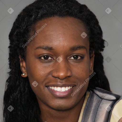 Joyful black young-adult female with long  brown hair and brown eyes