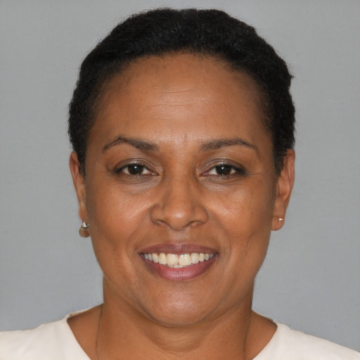 Joyful latino adult female with short  brown hair and brown eyes