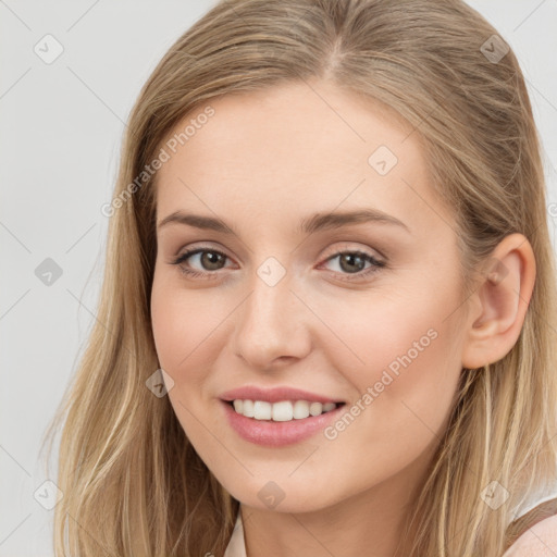 Joyful white young-adult female with long  brown hair and grey eyes