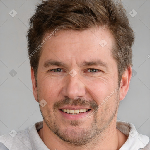 Joyful white adult male with short  brown hair and grey eyes