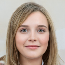 Joyful white young-adult female with long  brown hair and blue eyes