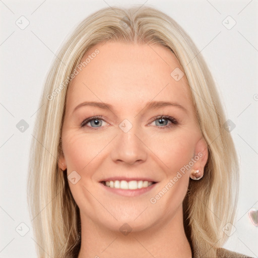 Joyful white young-adult female with long  brown hair and blue eyes