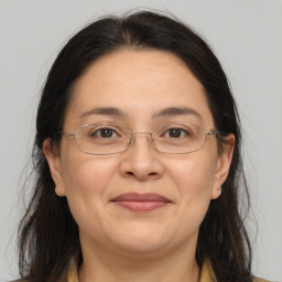 Joyful white adult female with medium  brown hair and brown eyes