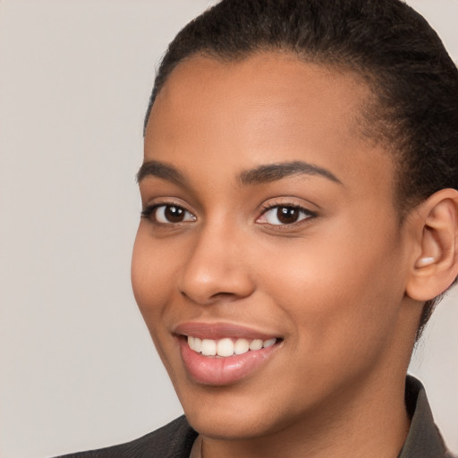 Joyful latino young-adult female with short  brown hair and brown eyes