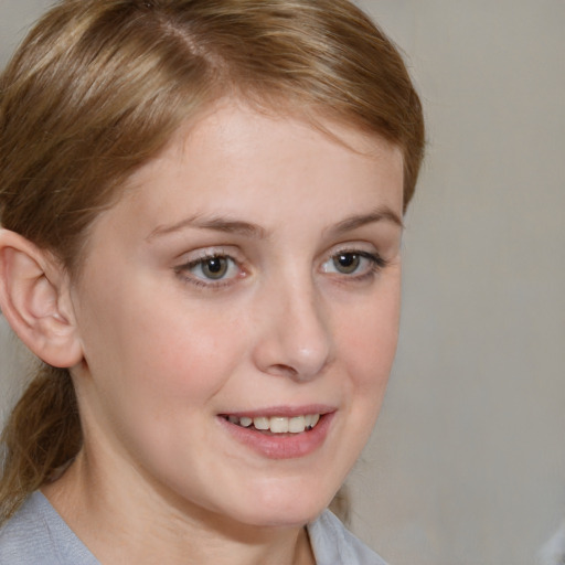 Joyful white young-adult female with medium  brown hair and blue eyes