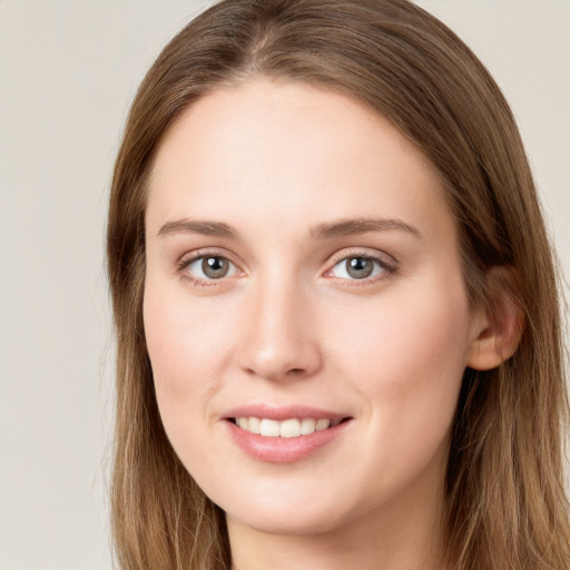 Joyful white young-adult female with long  brown hair and grey eyes