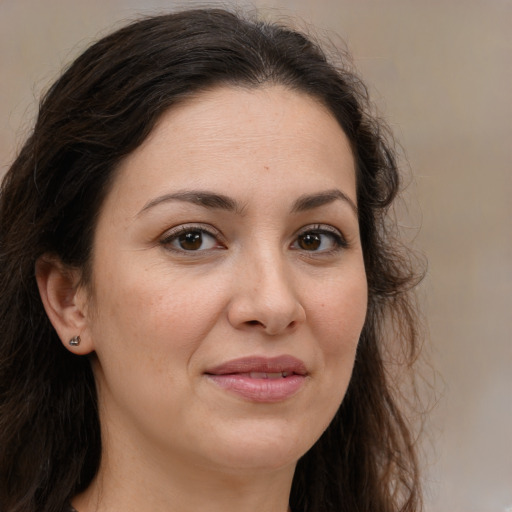 Joyful white adult female with long  brown hair and brown eyes