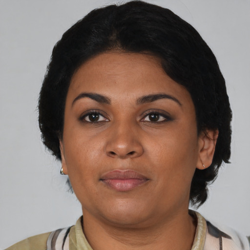 Joyful black young-adult female with medium  black hair and brown eyes