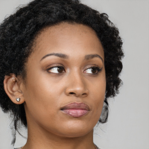 Neutral black young-adult female with medium  brown hair and brown eyes