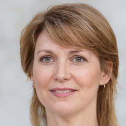 Joyful white adult female with medium  brown hair and grey eyes