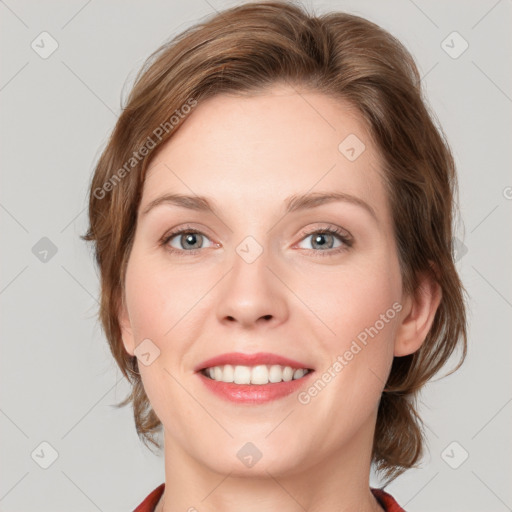 Joyful white young-adult female with medium  brown hair and blue eyes