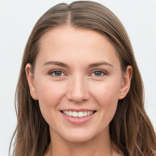 Joyful white young-adult female with long  brown hair and grey eyes