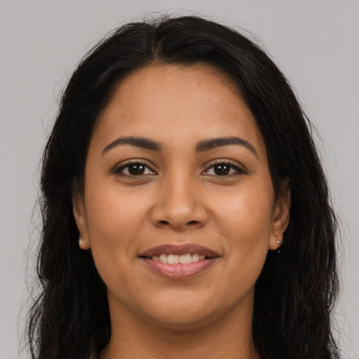 Joyful latino young-adult female with long  brown hair and brown eyes
