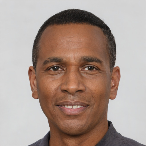 Joyful latino adult male with short  black hair and brown eyes