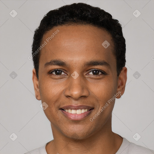 Joyful black young-adult male with short  black hair and brown eyes