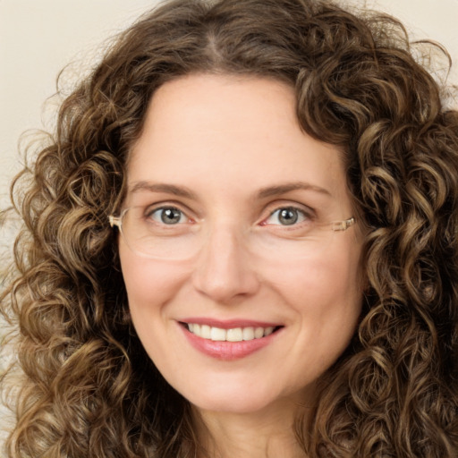 Joyful white young-adult female with long  brown hair and green eyes