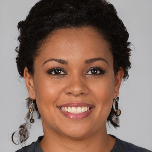 Joyful black young-adult female with medium  brown hair and brown eyes