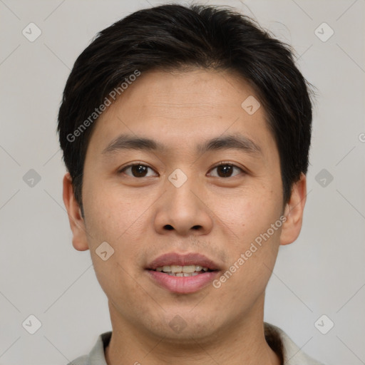 Joyful asian young-adult male with short  brown hair and brown eyes