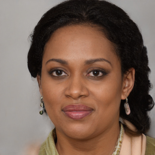 Joyful black adult female with medium  brown hair and brown eyes