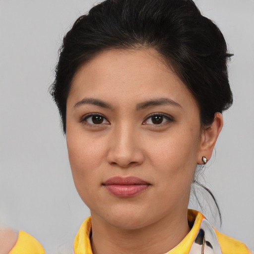 Joyful asian young-adult female with short  brown hair and brown eyes