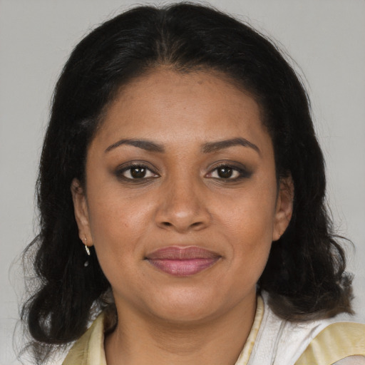 Joyful latino adult female with medium  brown hair and brown eyes
