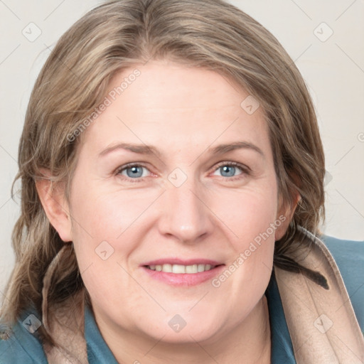 Joyful white adult female with medium  brown hair and blue eyes