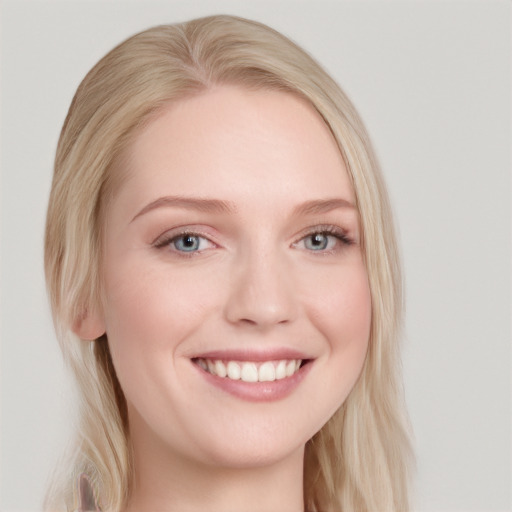 Joyful white young-adult female with long  blond hair and blue eyes