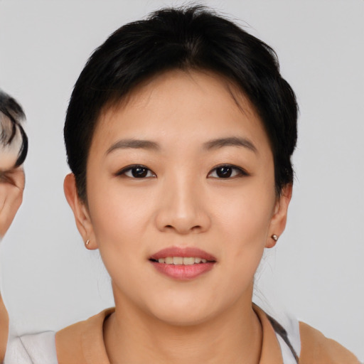 Joyful asian young-adult female with short  black hair and brown eyes