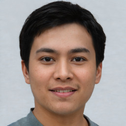 Joyful asian young-adult male with short  black hair and brown eyes