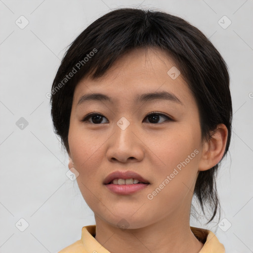 Joyful asian young-adult female with short  brown hair and brown eyes