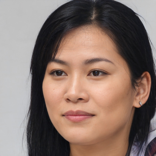 Joyful asian young-adult female with long  black hair and brown eyes