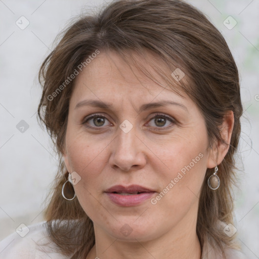 Joyful white adult female with medium  brown hair and grey eyes