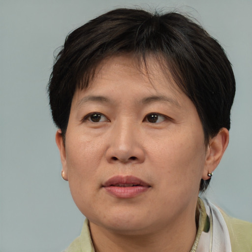 Joyful asian adult female with short  brown hair and brown eyes