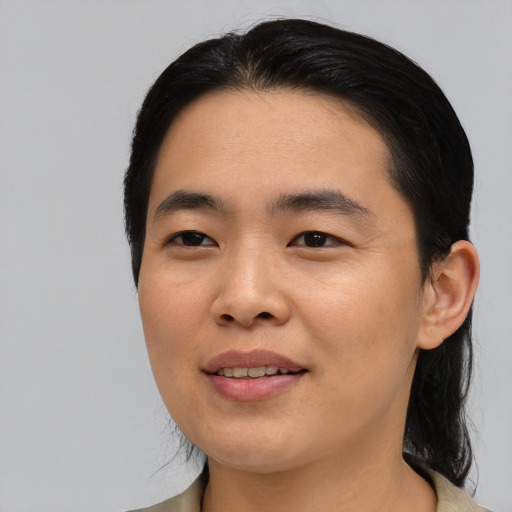 Joyful asian young-adult male with medium  black hair and brown eyes