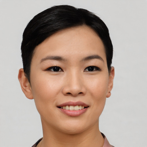 Joyful asian young-adult female with short  black hair and brown eyes