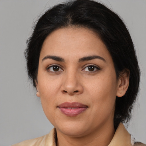 Joyful latino adult female with medium  brown hair and brown eyes