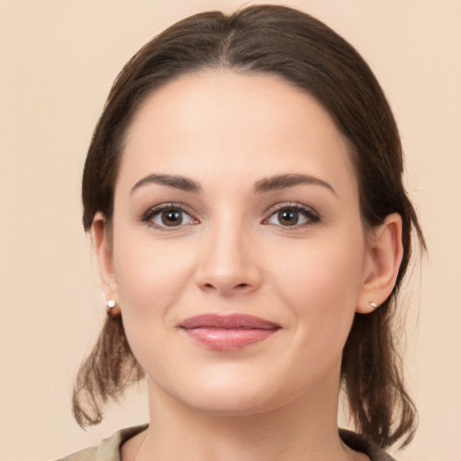 Joyful white young-adult female with medium  brown hair and brown eyes