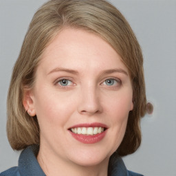 Joyful white young-adult female with medium  brown hair and blue eyes