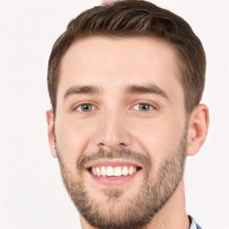 Joyful white young-adult male with short  brown hair and grey eyes