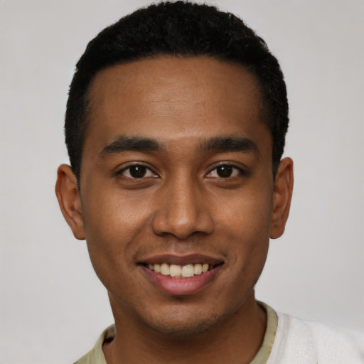 Joyful black young-adult male with short  black hair and brown eyes