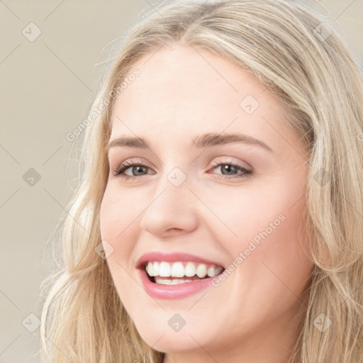 Joyful white young-adult female with long  brown hair and blue eyes