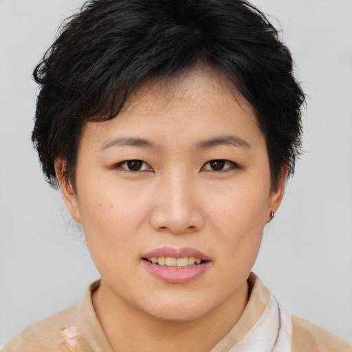 Joyful asian young-adult female with short  brown hair and brown eyes