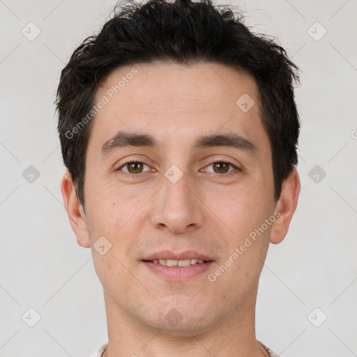 Joyful white young-adult male with short  black hair and brown eyes