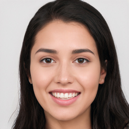 Joyful white young-adult female with long  black hair and brown eyes