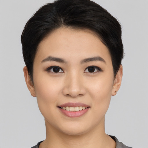 Joyful asian young-adult female with short  black hair and brown eyes