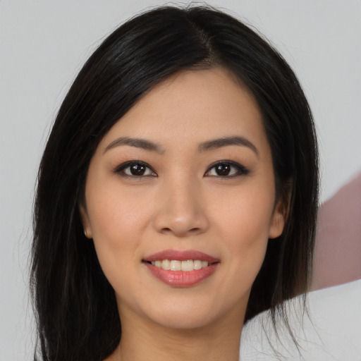 Joyful asian young-adult female with long  black hair and brown eyes