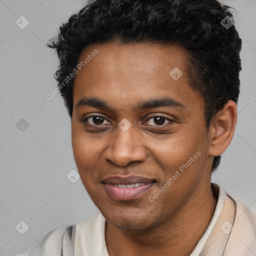 Joyful black young-adult male with short  black hair and brown eyes