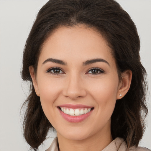 Joyful white young-adult female with long  brown hair and brown eyes