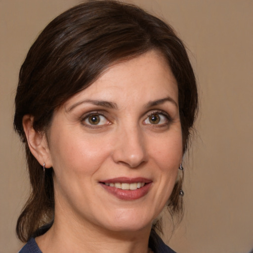 Joyful white adult female with medium  brown hair and brown eyes