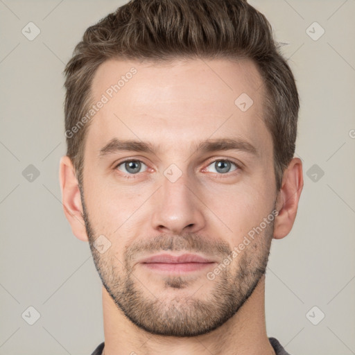 Joyful white young-adult male with short  brown hair and grey eyes